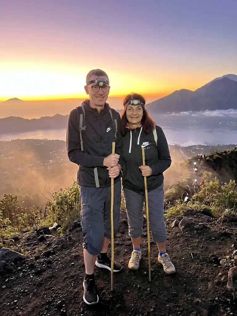 Couple enjoying Mount Batur Sunrise Trekking, romantic sunrise hike with panoramic views of Lake Batur and Mount Agung